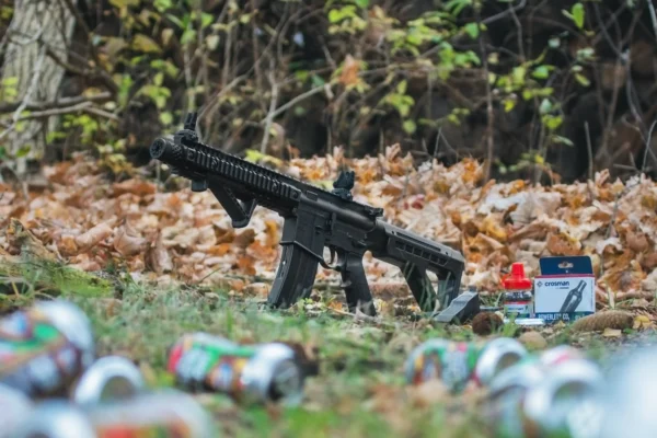 Crosman DPMS™ SBR CO2 BB Air Rifle Lifetsyle Outdoors Sitting in a Yard with Can Targets
